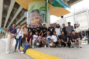 Kaisa sa Sining visual artists pose with one of the collaborative mural paintings on a beam post under the Tagum City flyover.