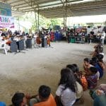 Kids and adults watch a performance at an evacuation center in Barangay San Miguel.