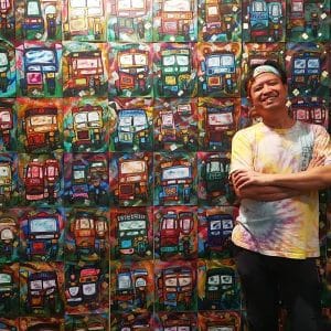 Leonardo Cariño, Cultural Development Officer and Artistic Director of Ramon Magsaysay Memorial Colleges (RMMC) Teatro Ambahanon poses with his artwork.